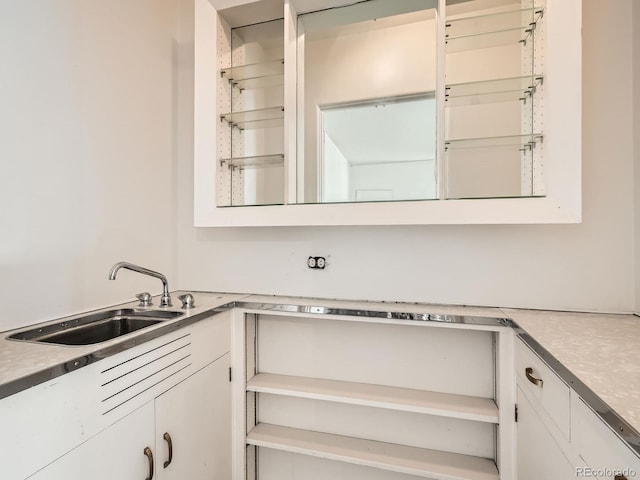 kitchen featuring white cabinets and sink