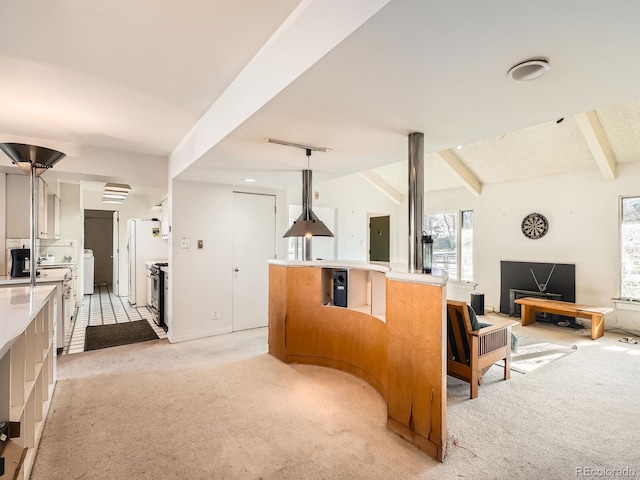 kitchen with vaulted ceiling with beams, stainless steel range, pendant lighting, and light colored carpet