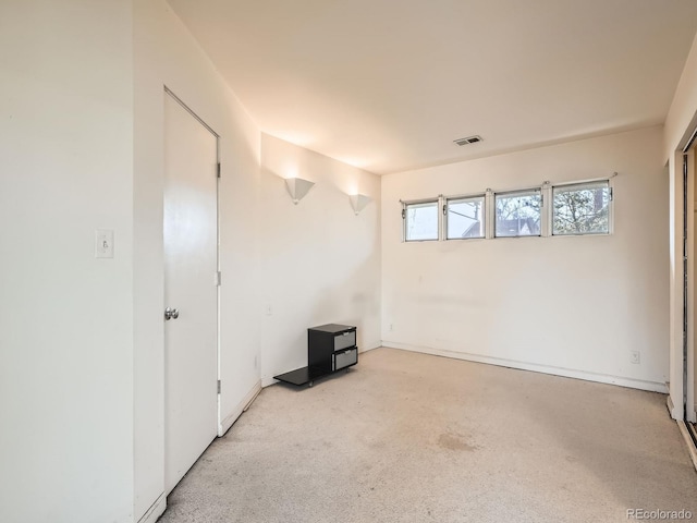 unfurnished room with light carpet