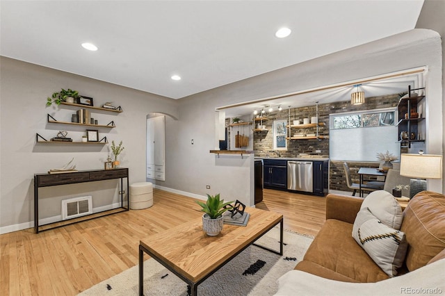 living room featuring light hardwood / wood-style flooring and sink