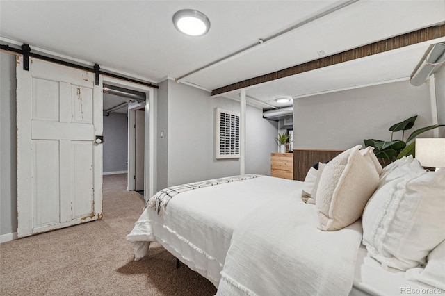 carpeted bedroom featuring a barn door