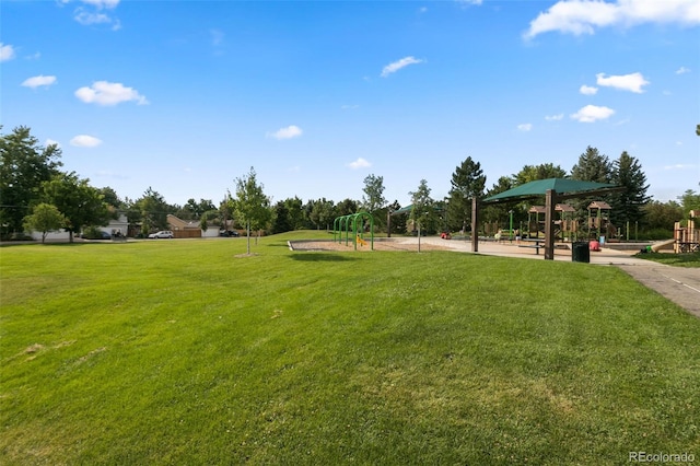 view of property's community featuring a playground and a lawn