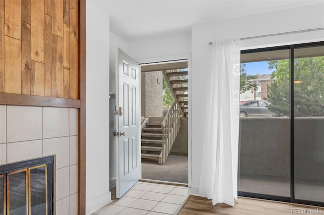 20 S Boulder Cir Unit 2109, Boulder, CO 80303 - doorway to outside featuring plenty of natural light, stairs, a fireplace, and wood finished floors
