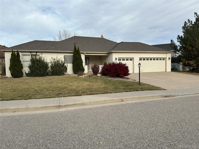 view of front of home featuring a garage and a front lawn