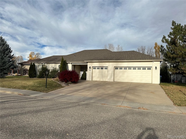 view of front of property with a garage and a front yard