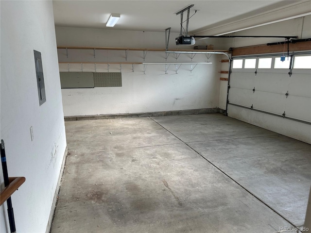 garage with a garage door opener and electric panel