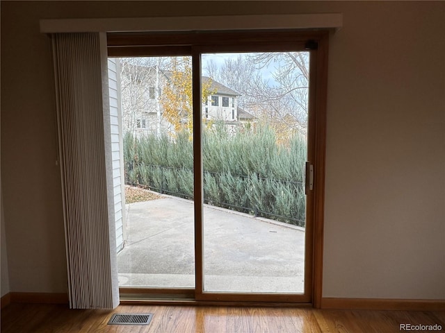 doorway with hardwood / wood-style floors