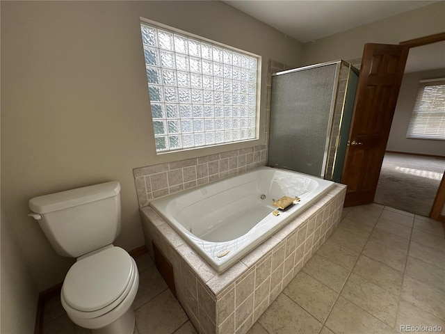 bathroom featuring plus walk in shower, tile patterned floors, and toilet