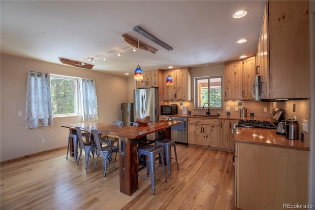 344 Puma Pl, Fairplay, CO 80440 - kitchen featuring appliances with stainless steel finishes, recessed lighting, light wood finished floors, pendant lighting, and tasteful backsplash