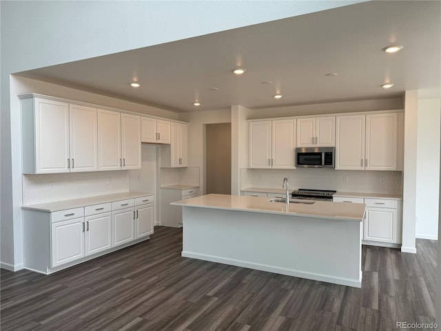 kitchen featuring white cabinets, appliances with stainless steel finishes, and a kitchen island with sink