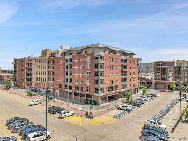 2229 Blake St Unit 505, Denver, CO 80205 - view of apartment building / complex featuring uncovered parking