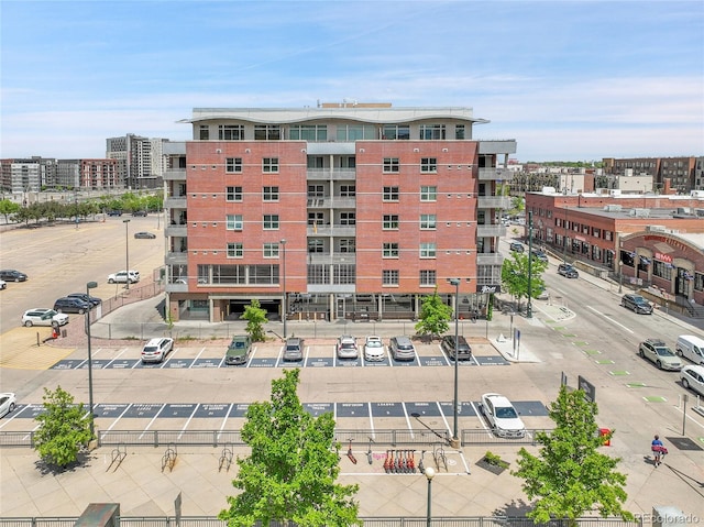 2229 Blake St Unit 505, Denver, CO 80205 - view of building exterior with uncovered parking and a city view