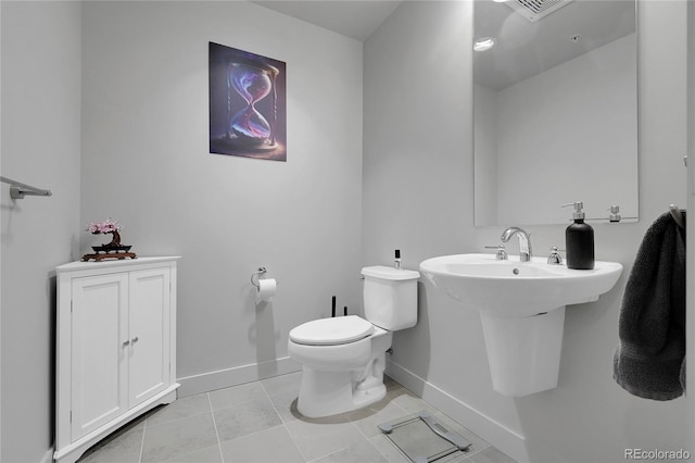 2229 Blake St Unit 505, Denver, CO 80205 - bathroom featuring baseboards, toilet, and tile patterned floors