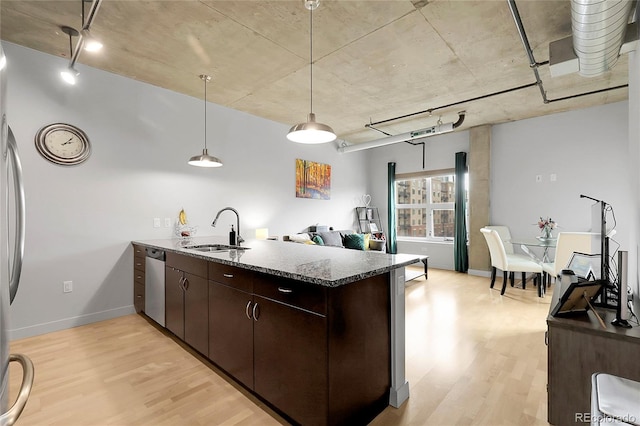 2229 Blake St Unit 505, Denver, CO 80205 - kitchen with a sink, dishwasher, light wood-type flooring, a peninsula, and dark brown cabinets