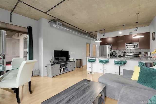 2229 Blake St Unit 505, Denver, CO 80205 - living area featuring light wood-style floors