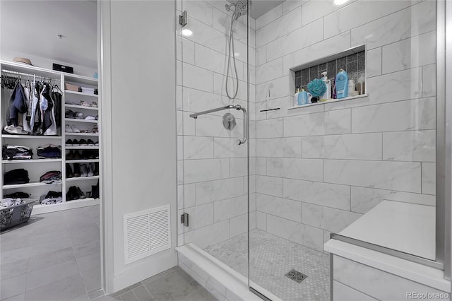 2229 Blake St Unit 505, Denver, CO 80205 - bathroom featuring a shower stall, a spacious closet, and tile patterned floors