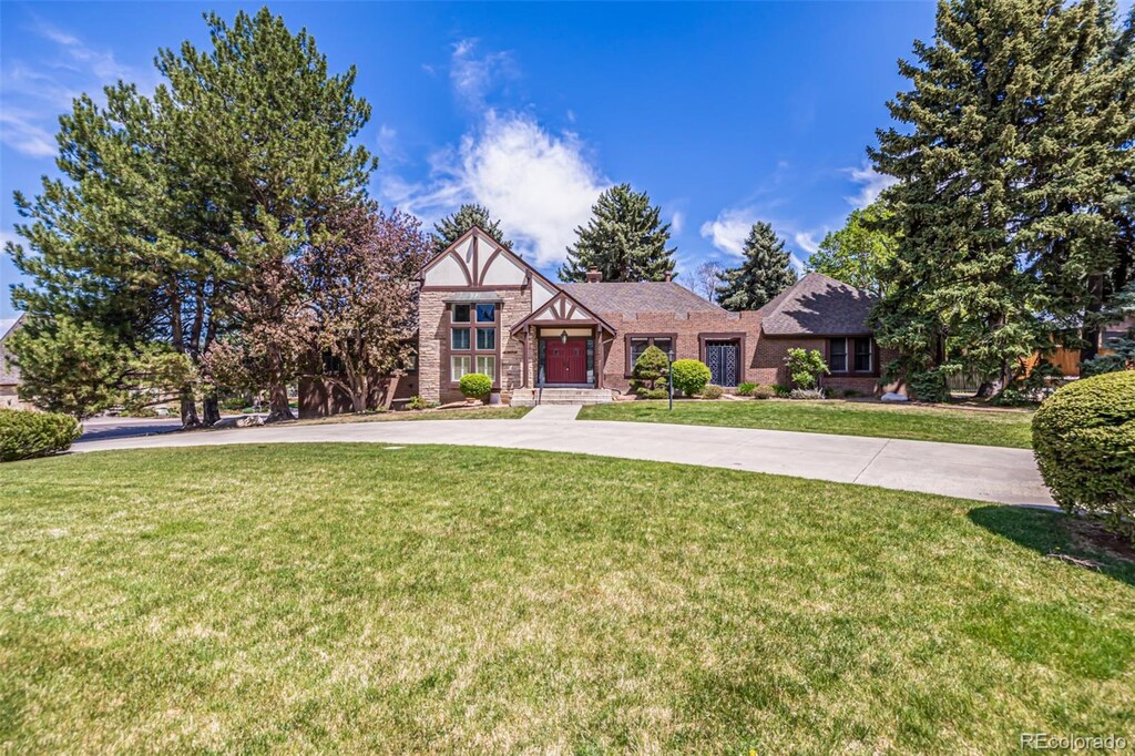 5365 W Princeton Dr, Denver, CO 80235 - tudor house featuring brick siding and a front lawn