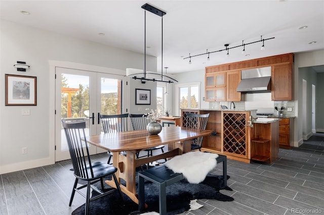 dining room with track lighting, a notable chandelier, and french doors