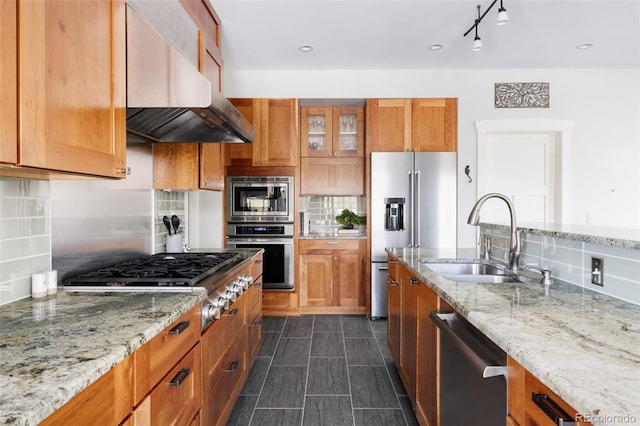 kitchen featuring sink, stainless steel appliances, extractor fan, light stone countertops, and decorative backsplash