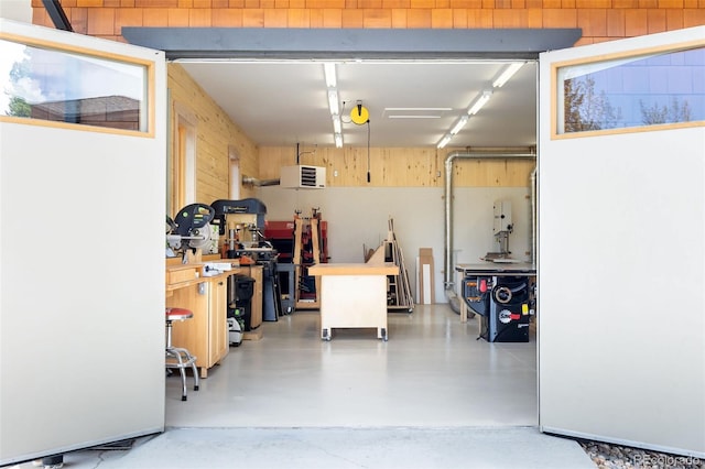 garage with wooden walls and a workshop area