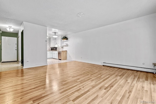 unfurnished living room featuring light wood-type flooring, a baseboard heating unit, and a textured ceiling