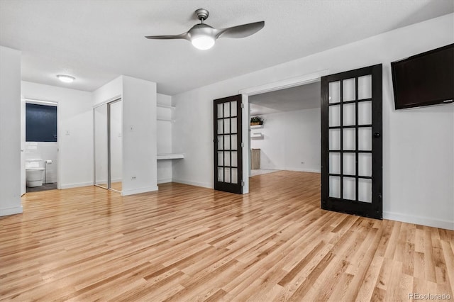 unfurnished living room with ceiling fan, light hardwood / wood-style floors, and a textured ceiling