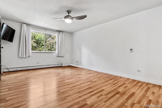 unfurnished room with light wood-type flooring, a baseboard heating unit, ceiling fan, and a textured ceiling