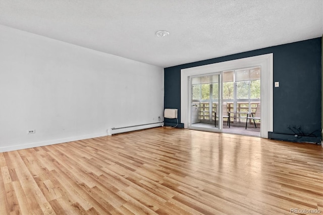 705 S Alton Way Unit 6B, Denver, CO 80247 - empty room featuring a baseboard heating unit, wood finished floors, and a textured ceiling