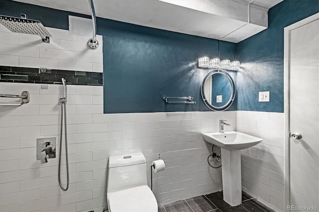 705 S Alton Way Unit 6B, Denver, CO 80247 - bathroom featuring tiled shower, tile walls, and wainscoting
