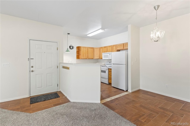 10784 W 63rd Pl Unit 205, Arvada, CO 80004 - kitchen with white appliances, open shelves, a chandelier, light countertops, and a peninsula