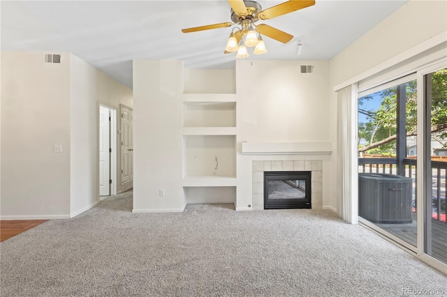 10784 W 63rd Pl Unit 205, Arvada, CO 80004 - unfurnished living room with carpet flooring, a tiled fireplace, and ceiling fan