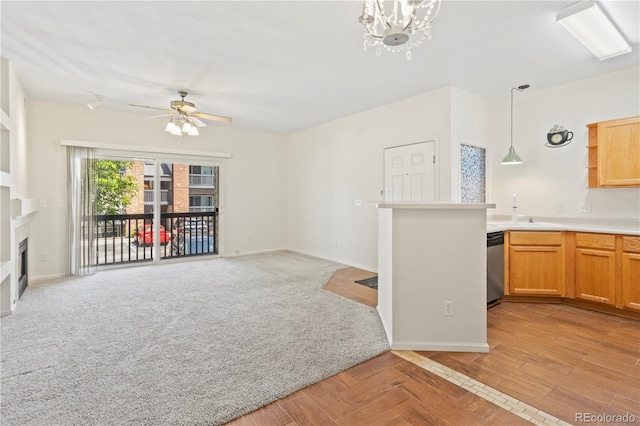 10784 W 63rd Pl Unit 205, Arvada, CO 80004 - unfurnished living room with a ceiling fan, a fireplace, and a chandelier