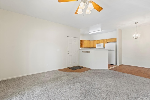 10784 W 63rd Pl Unit 205, Arvada, CO 80004 - unfurnished living room with carpet, a chandelier, and a ceiling fan