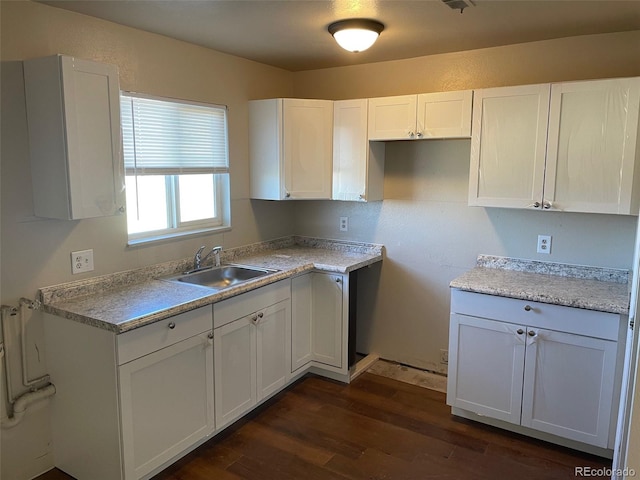 kitchen featuring white cabinets, dark hardwood / wood-style flooring, and sink