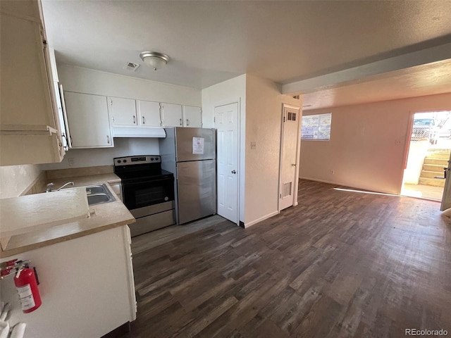 kitchen with dark hardwood / wood-style flooring, white cabinetry, sink, and appliances with stainless steel finishes