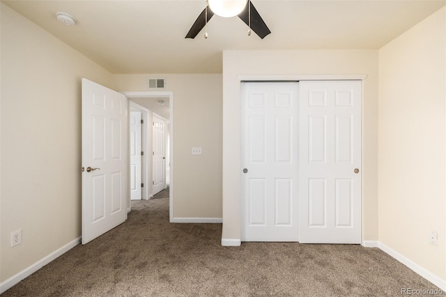 unfurnished bedroom with carpet flooring, a closet, and ceiling fan