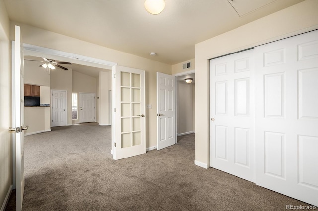 unfurnished bedroom featuring carpet flooring, a closet, and vaulted ceiling