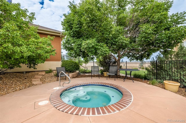 view of swimming pool with an in ground hot tub and a patio