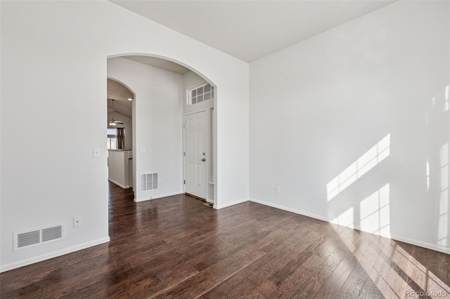 13135 Devils Thumb Pl, Peyton, CO 80831 - spare room with wood finished floors, baseboards, and arched walkways