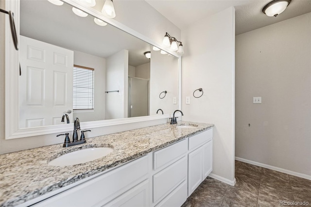 13135 Devils Thumb Pl, Peyton, CO 80831 - bathroom with double vanity and baseboards