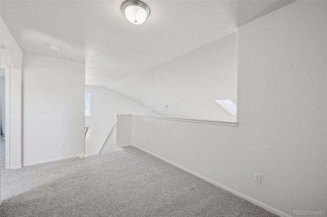 13135 Devils Thumb Pl, Peyton, CO 80831 - carpeted empty room with lofted ceiling, a textured ceiling, and baseboards