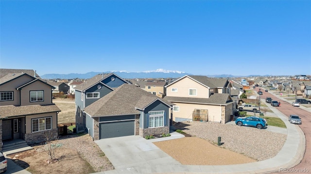 13135 Devils Thumb Pl, Peyton, CO 80831 - traditional-style house with a residential view, stone siding, an attached garage, and concrete driveway