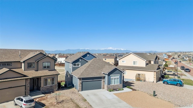 13135 Devils Thumb Pl, Peyton, CO 80831 - traditional home featuring a residential view, stone siding, a garage, concrete driveway, and a shingled roof
