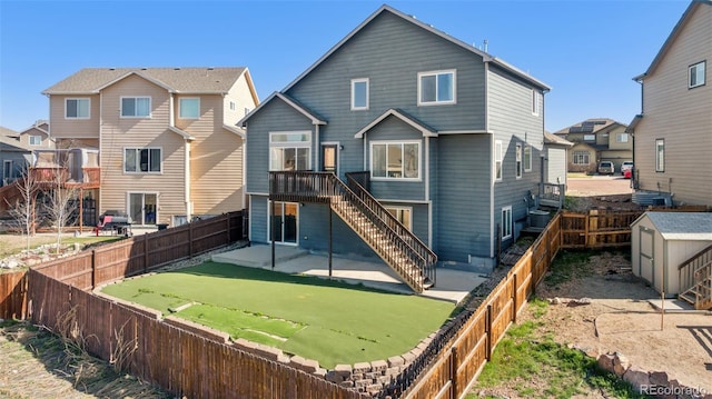 13135 Devils Thumb Pl, Peyton, CO 80831 - rear view of house featuring a patio, a fenced backyard, and stairs