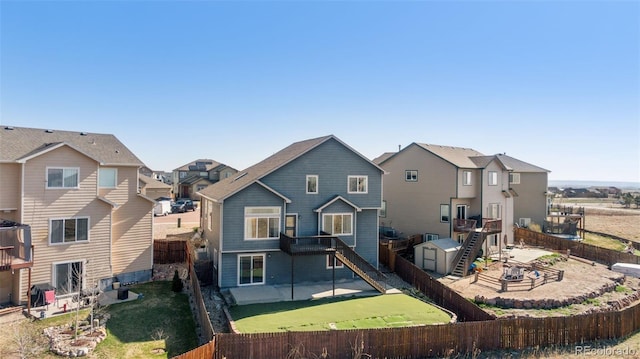 13135 Devils Thumb Pl, Peyton, CO 80831 - back of house with a fenced backyard, a patio, stairway, and a residential view