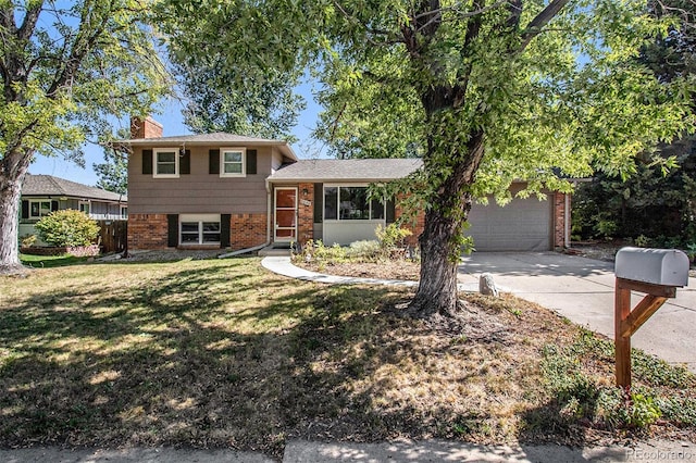 tri-level home featuring a garage and a front lawn