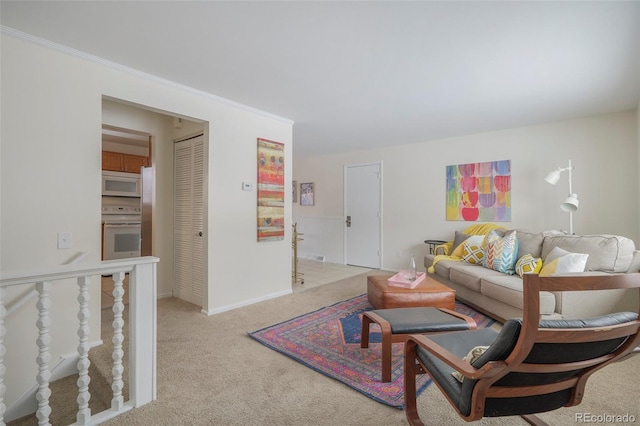 carpeted living room featuring ornamental molding