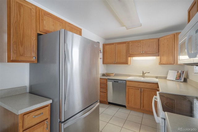 kitchen with sink, light tile patterned floors, and stainless steel appliances