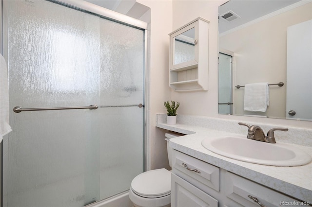 bathroom featuring vanity, toilet, an enclosed shower, and crown molding