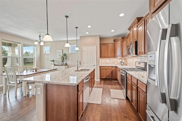 9530 Gray St, Westminster, CO 80031 - kitchen featuring appliances with stainless steel finishes, brown cabinets, dark wood-type flooring, backsplash, and recessed lighting